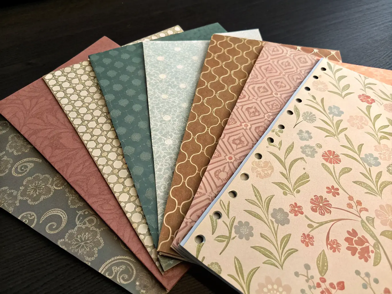 A close-up shot of various paper textures and weights, showcasing the tactile differences and visual appeal of each option available at Max Source Studio.